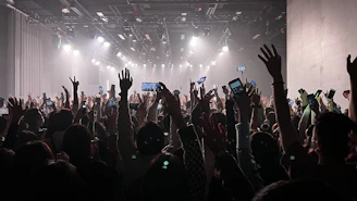 Fans holding up their phones capturing Mike’s energetic live show.