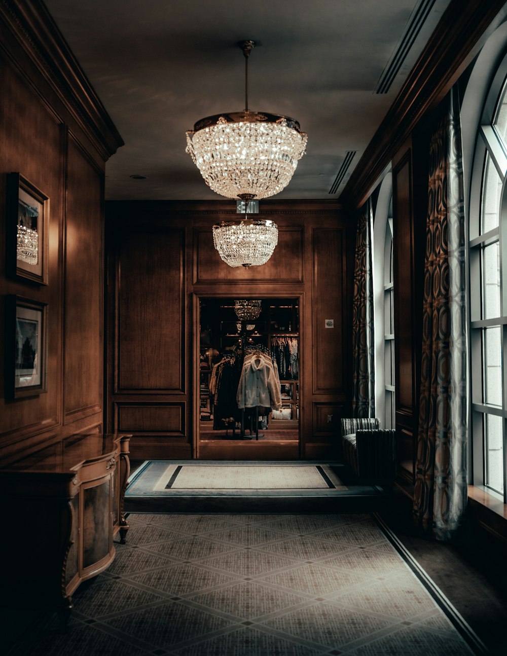 a chandelier hangs from the ceiling of a hallway