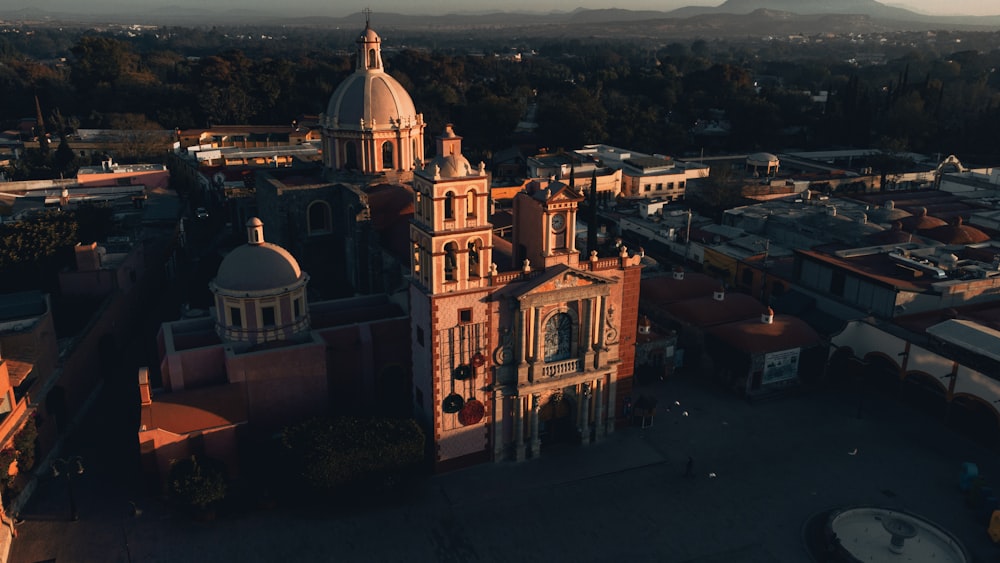 an aerial view of a church in a city