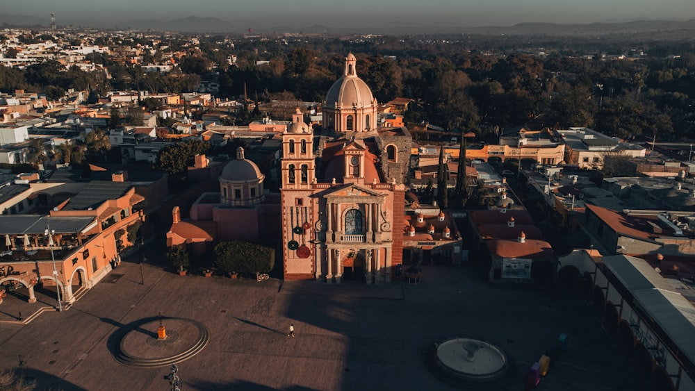 an aerial view of a church in a city