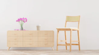 A sleek modern minimalist dressing table with clean lines and natural wood finish in a bright room.