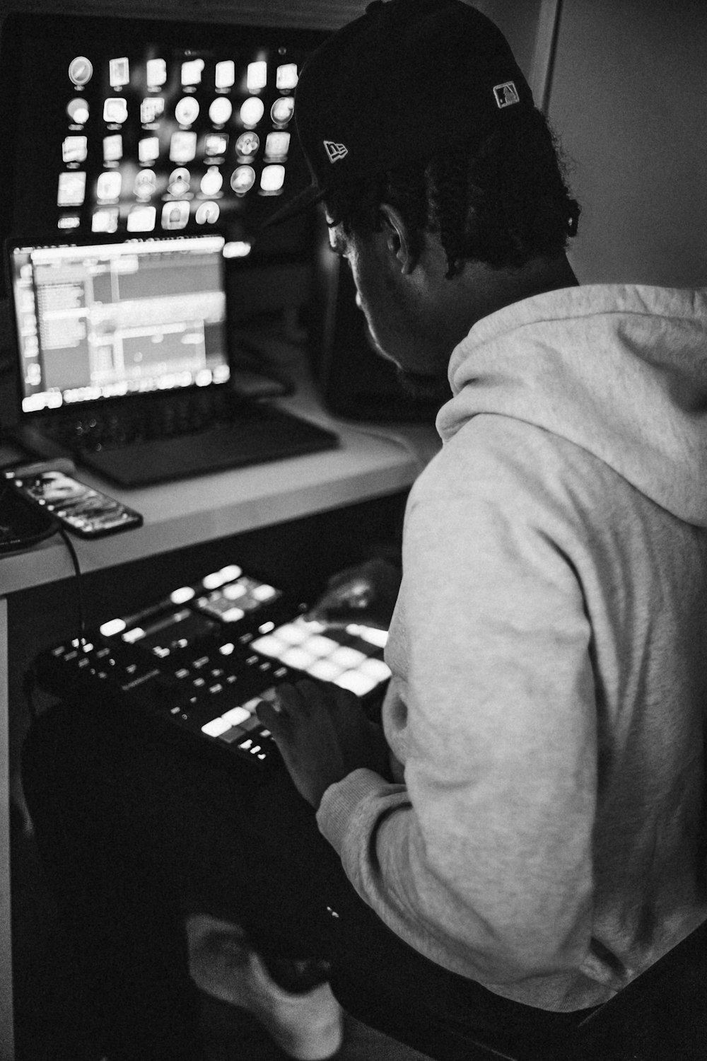 a man sitting in front of a computer screen