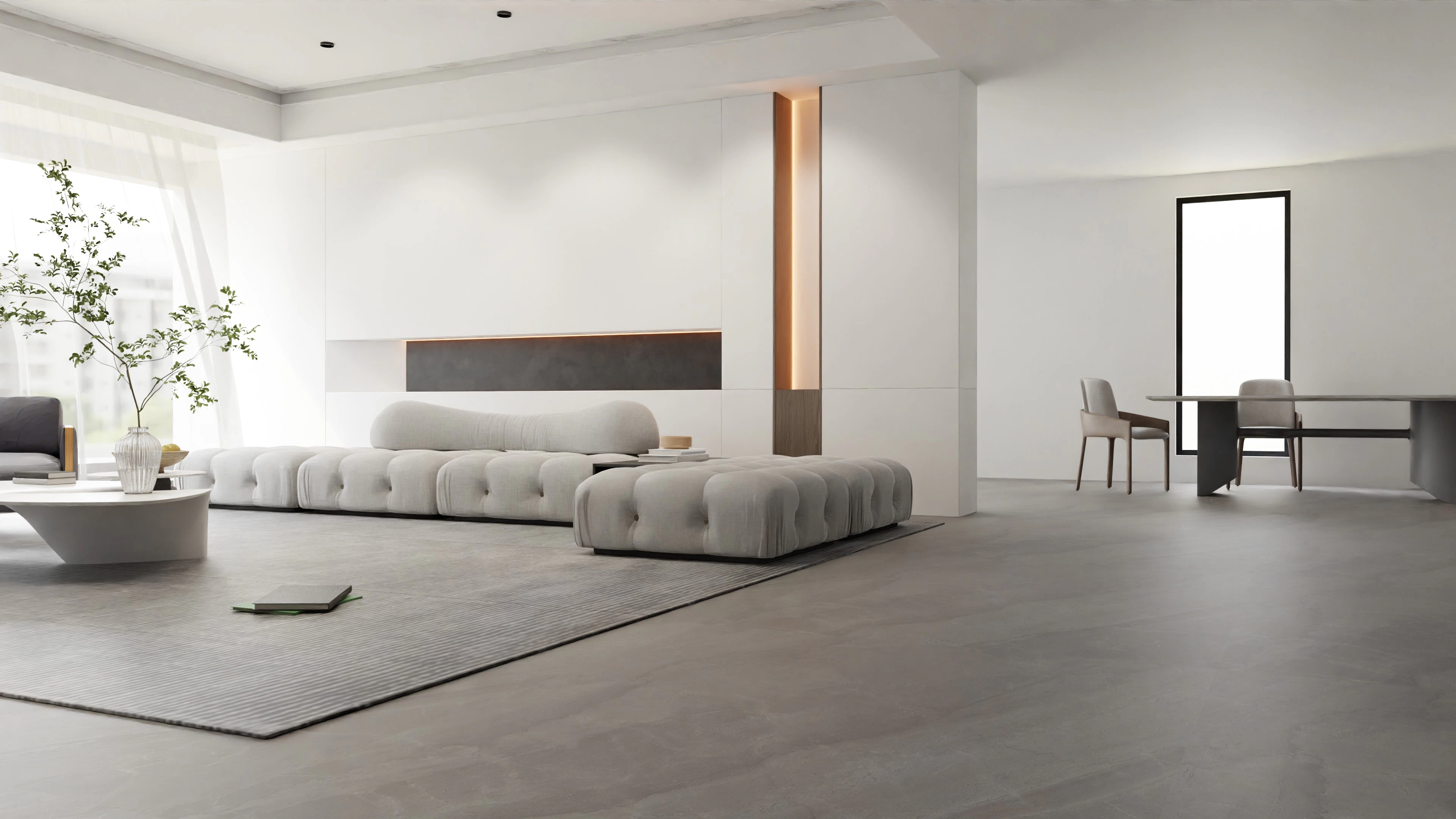 A minimalist apartment living area with a low white sofa and a slim wall light