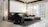 A modern living room with sleek, contemporary furniture including a black armchair and a sectional sofa in neutral tones. The room features a round coffee table with decorative items and large windows that allow natural light to illuminate the space. The walls are accented with a marble texture, and the ceiling has a unique, abstract chandelier.