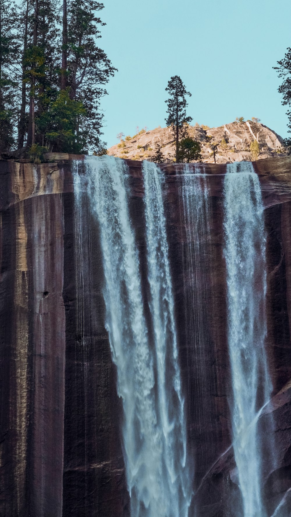 a tall waterfall with lots of water coming out of it