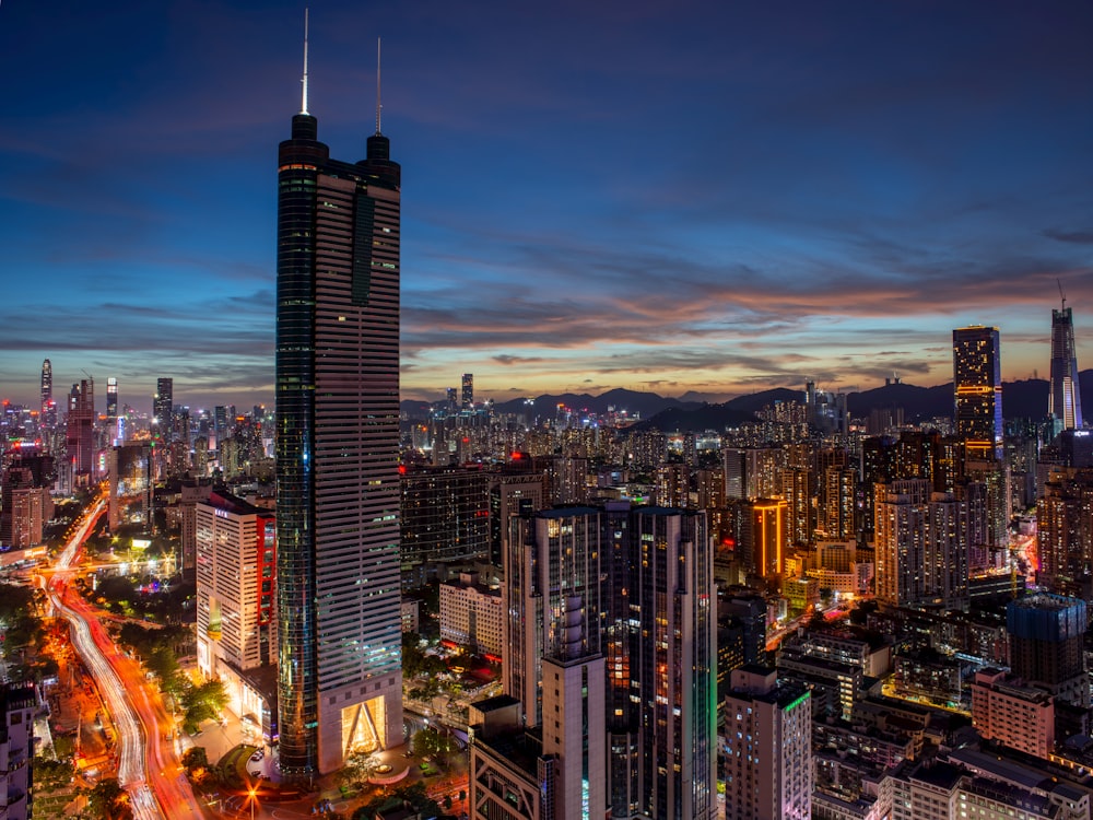 a view of a city at night from the top of a skyscraper