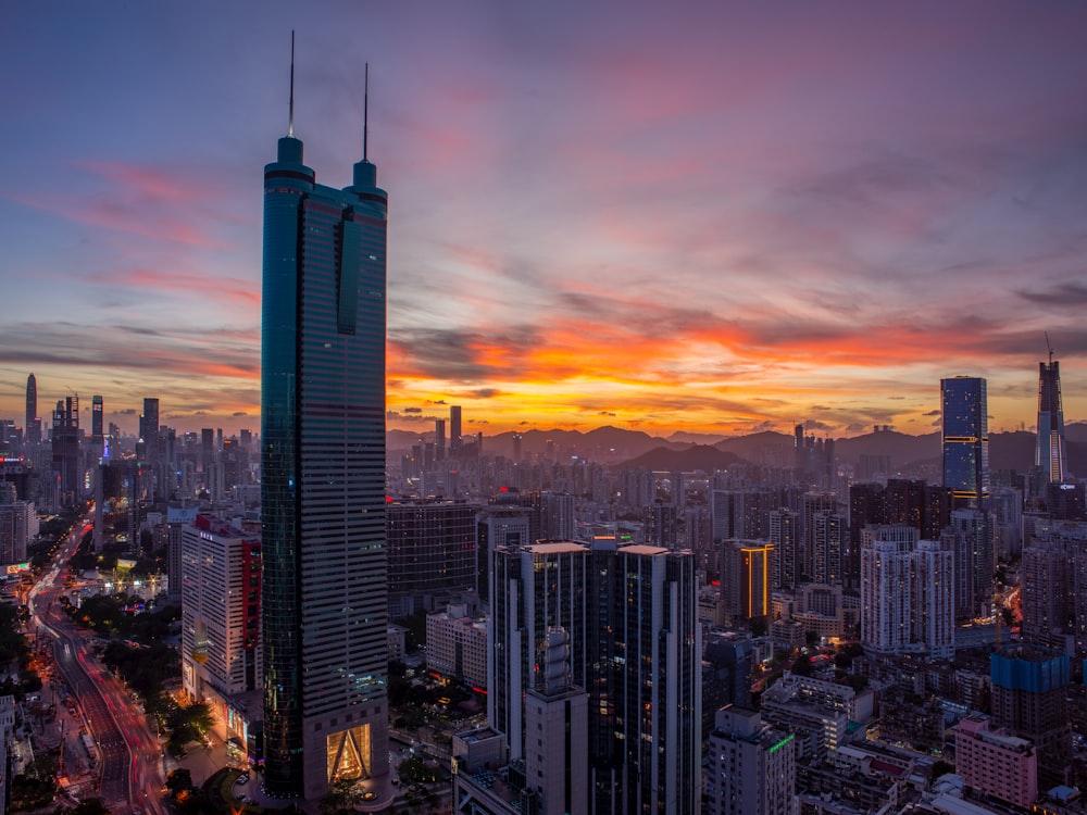 a view of a city at sunset from the top of a building