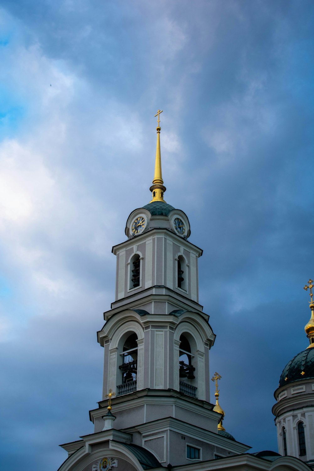 a tall white building with a clock on it's side