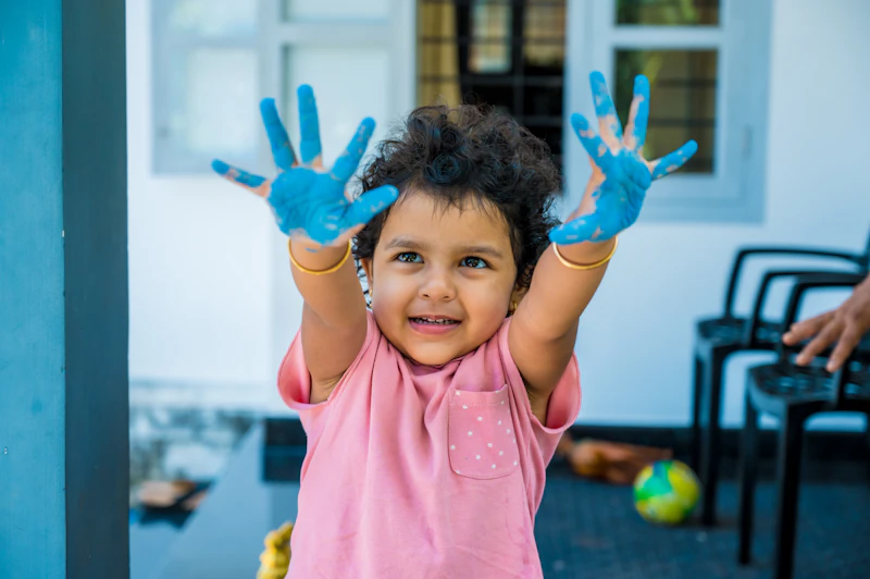 Indian girl engaged in hands-on sensory play during occupational therapy