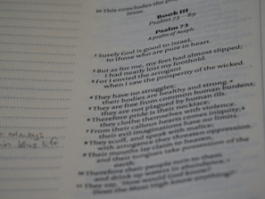 A close-up of a Bible page displaying text from Psalm 73. The text is printed in two columns with clear, readable font. Some handwritten notes are visible on the left margin.