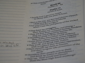 A close-up of a Bible page displaying text from Psalm 73. The text is printed in two columns with clear, readable font. Some handwritten notes are visible on the left margin.