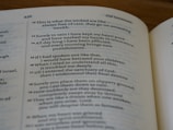 A close-up view of an open book showing text from a religious scripture, specifically from the Old Testament. The page number 436 is visible at the top. The text appears to be written in a poetic format with numbered verses and an organized layout.