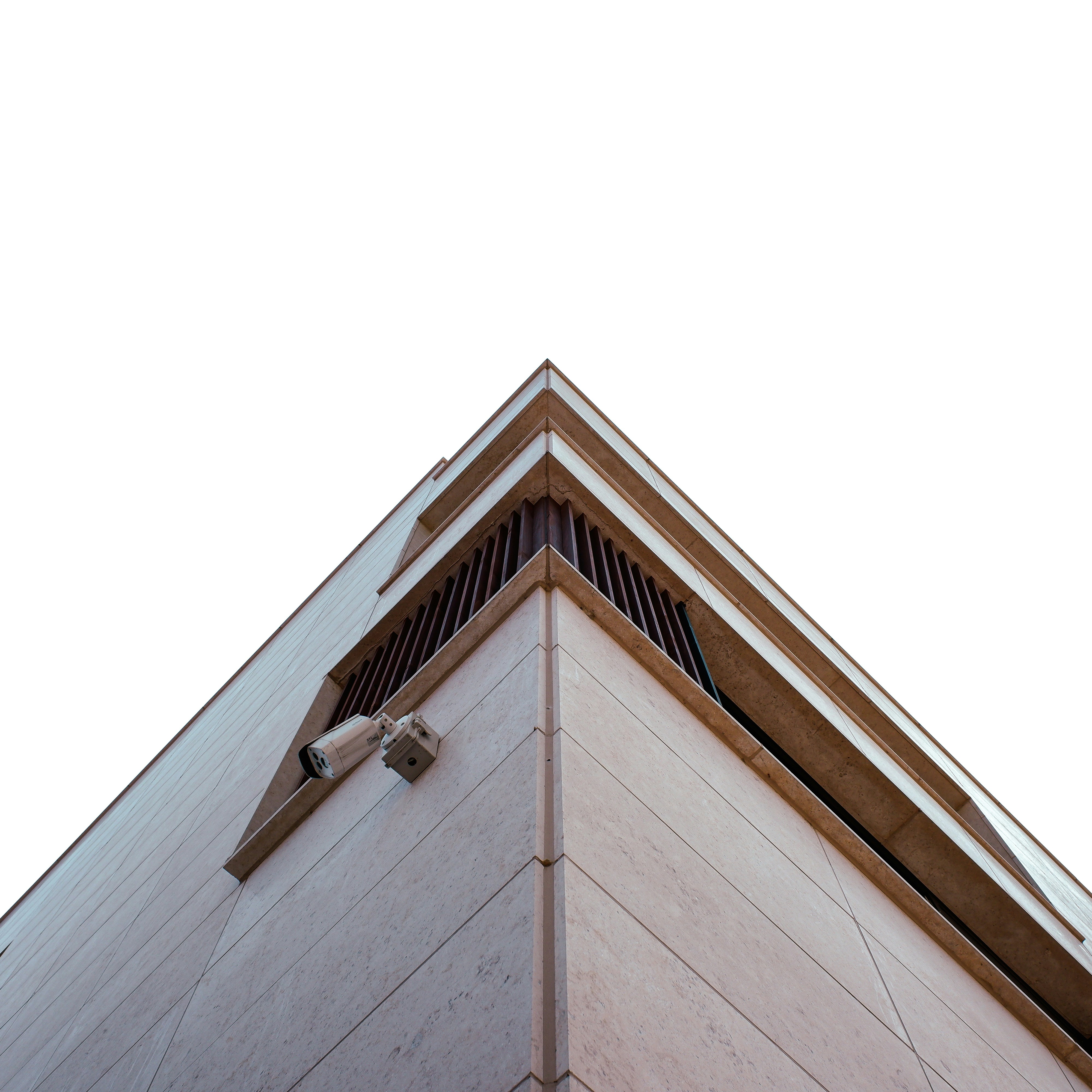 the corner of a building with a security camera on it