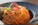a plate of rice with a tomato on top