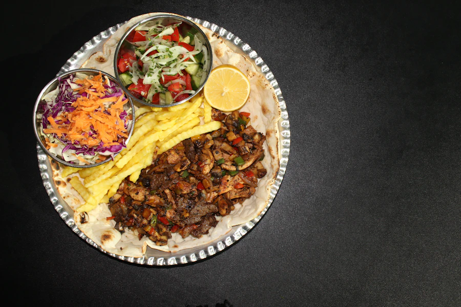 A grilled meat platter served with salad, slaw, fries and lemon