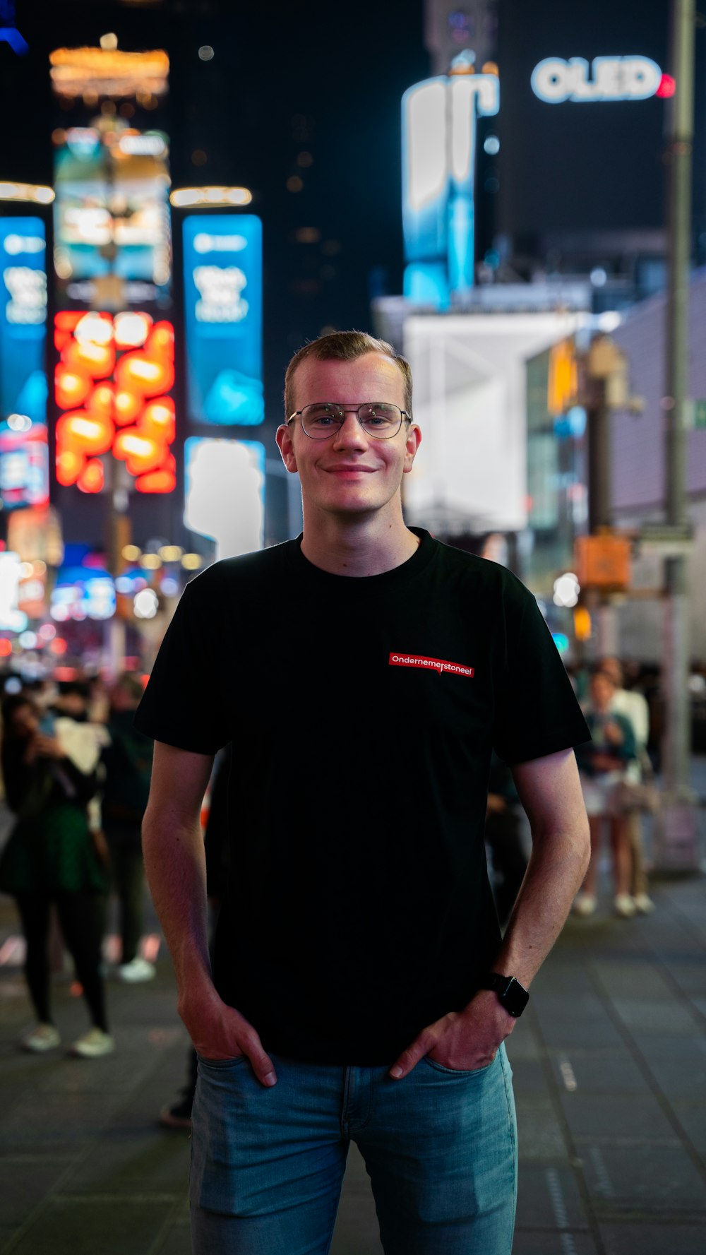 a man standing in the middle of a city at night