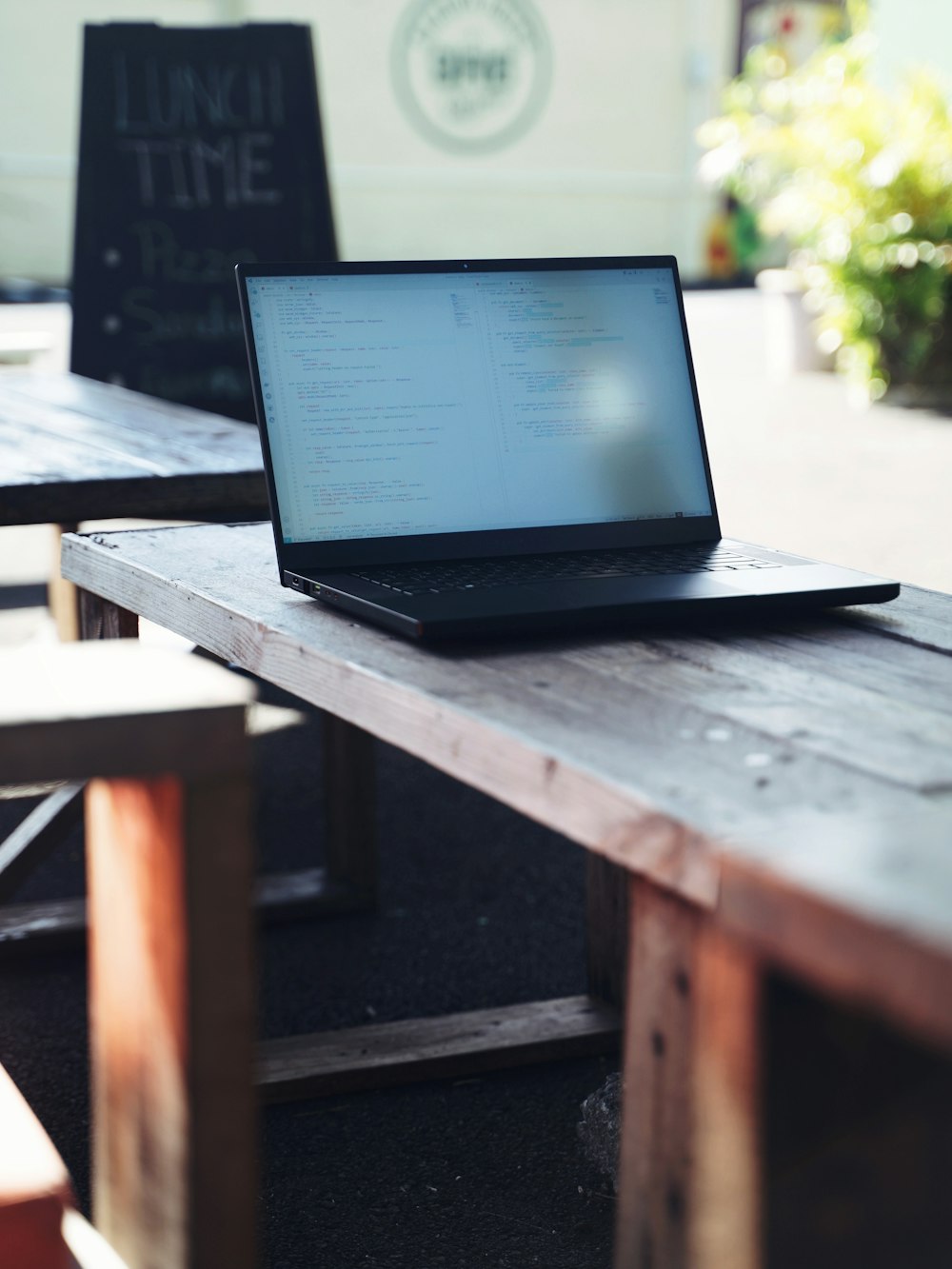 a laptop computer sitting on top of a wooden table