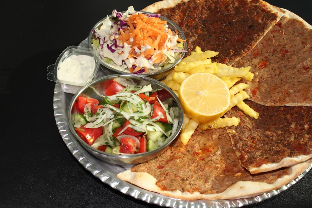 a plate of food that includes pancakes, coleslaw, and a salad