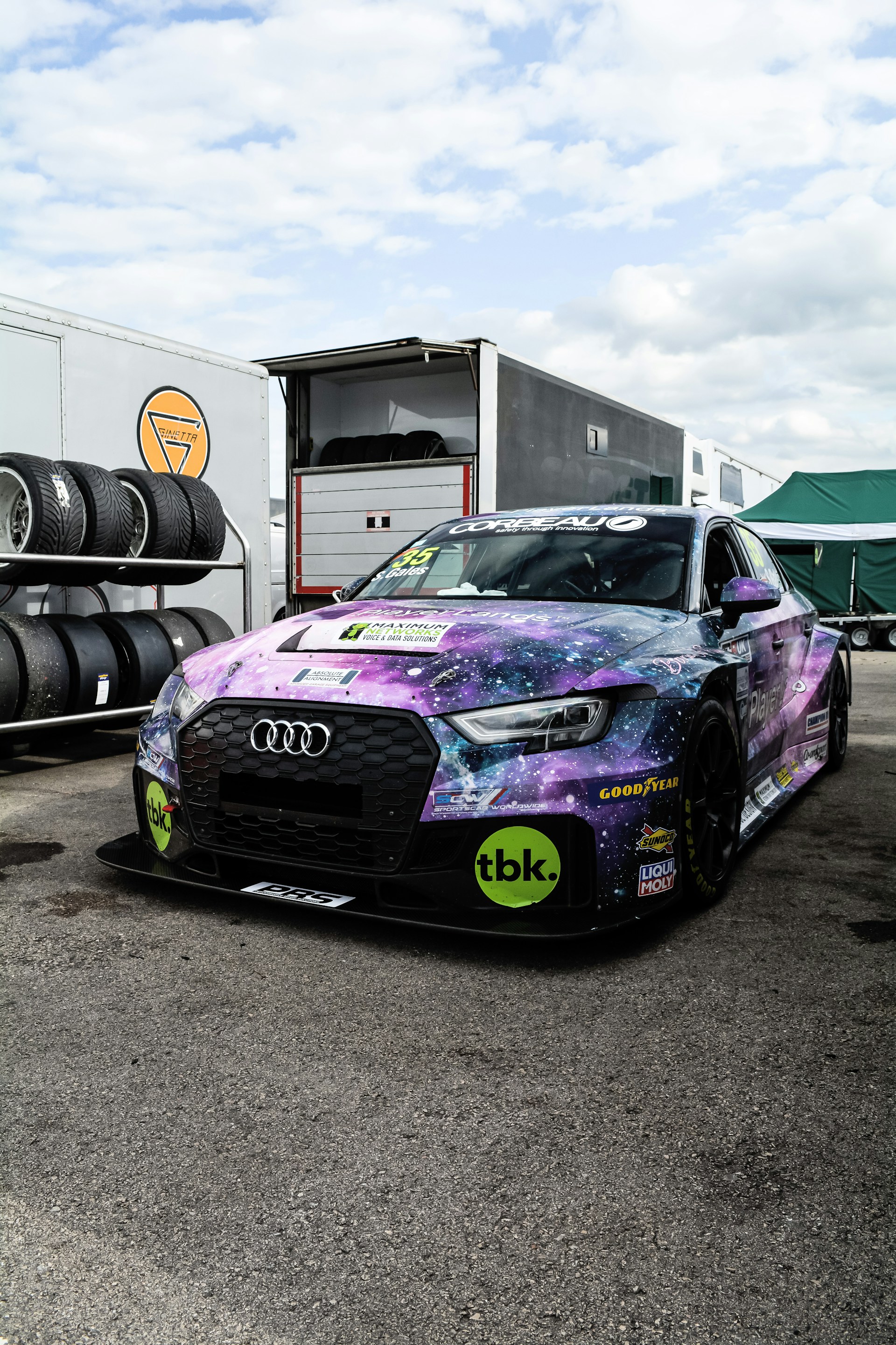 a purple and blue car parked in a parking lot
