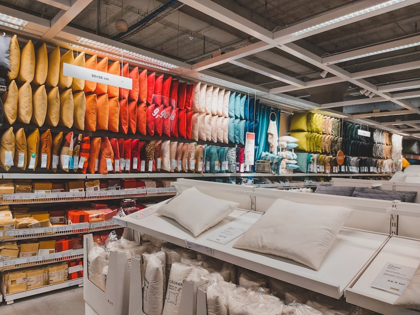 A vibrant display of shower liners and outdoor reversible throw pillows.