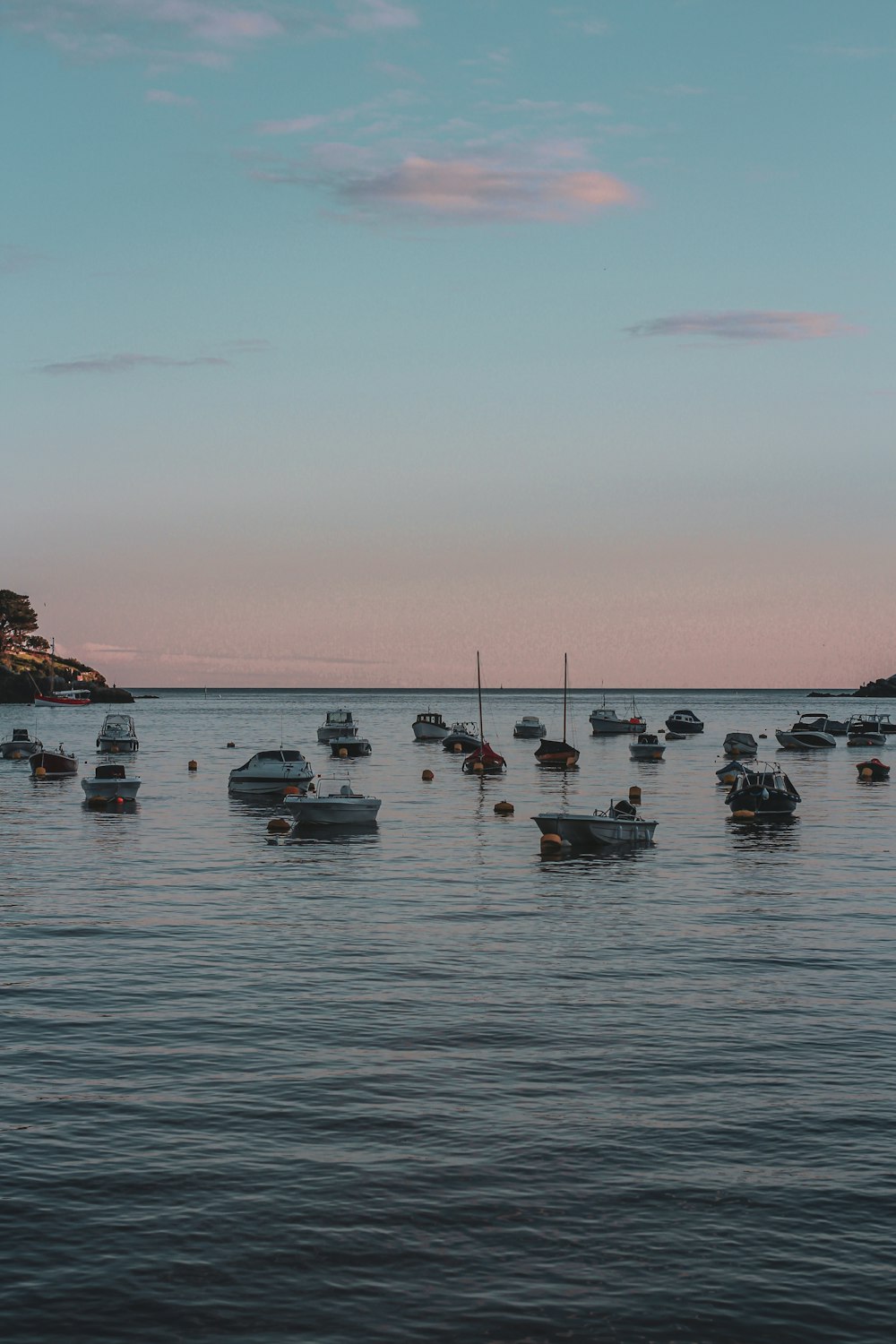 a group of boats floating on top of a body of water