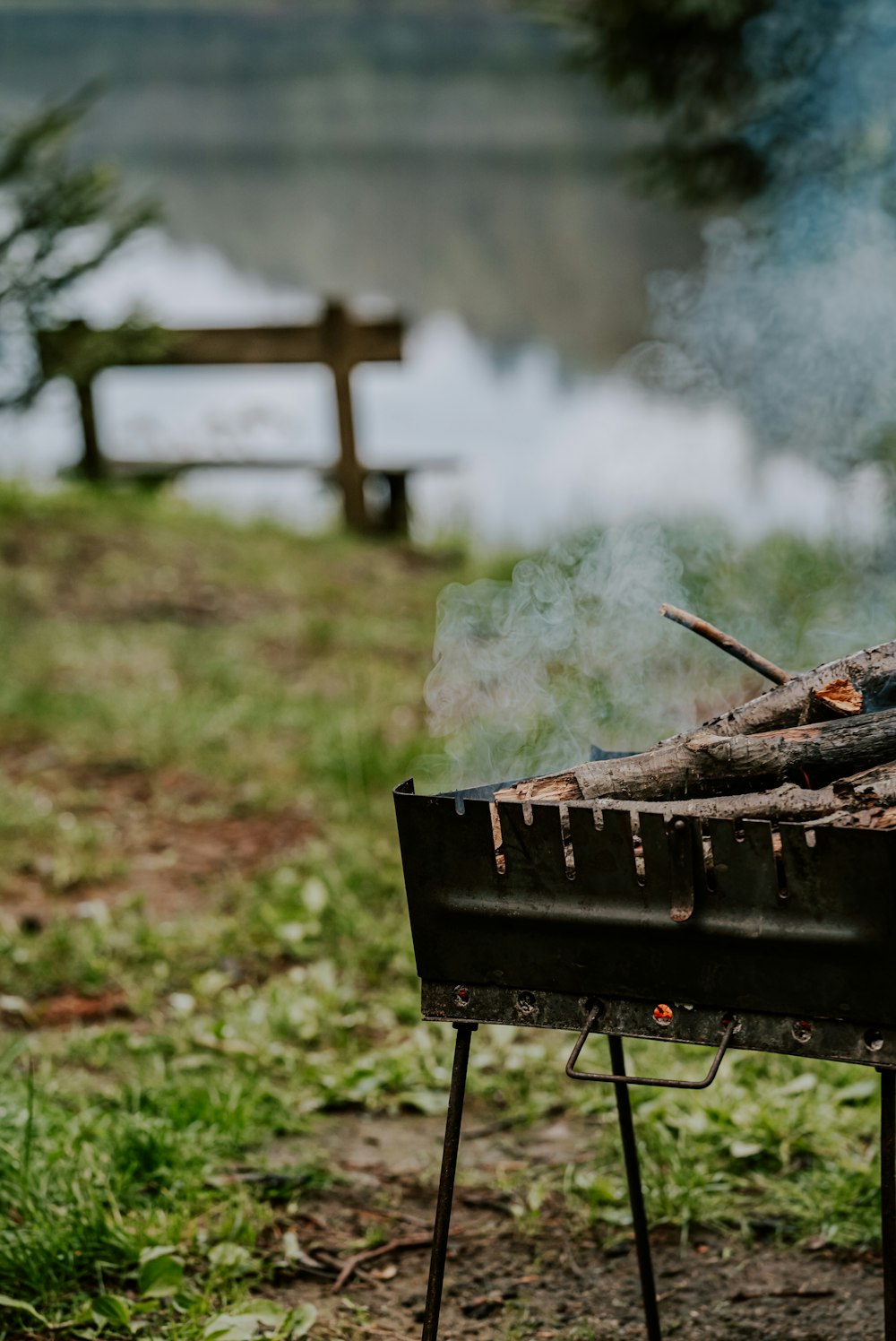 a bbq grill with smoke coming out of it