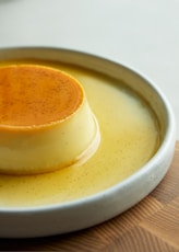 a small dessert on a white plate on a wooden table