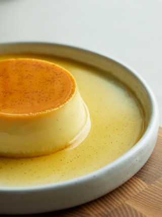 a small dessert on a white plate on a wooden table