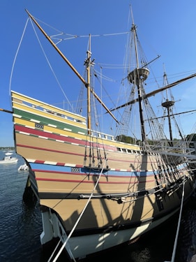 a large wooden boat docked at a pier