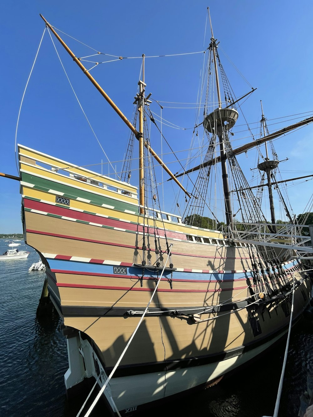 a large wooden boat docked at a pier