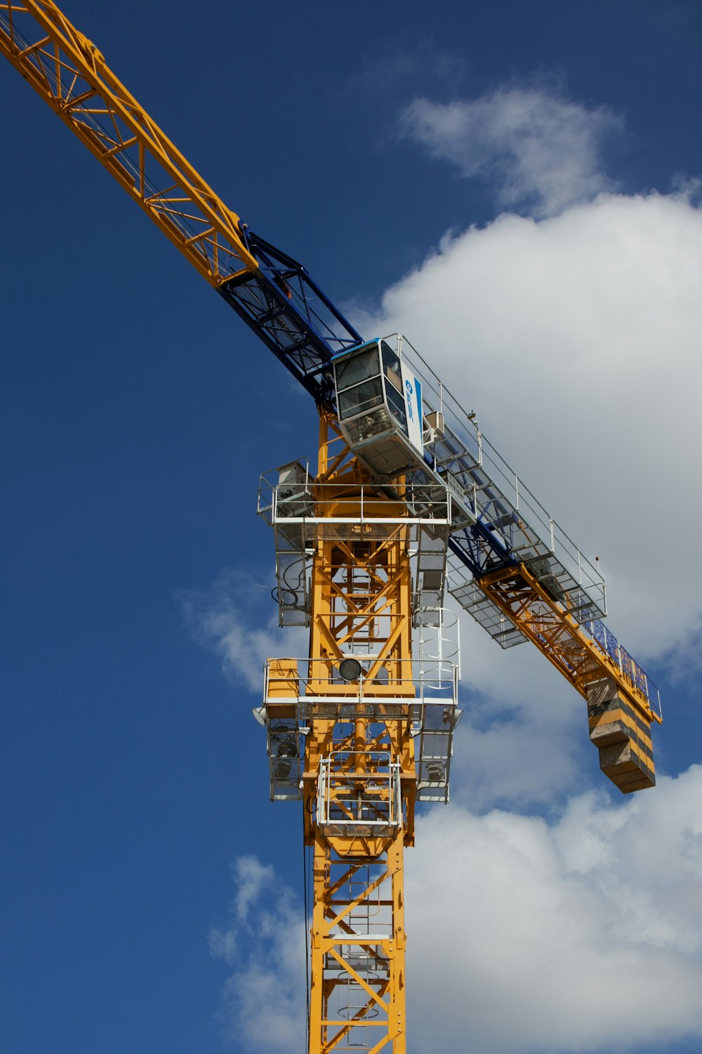 a yellow crane with a blue sky in the background