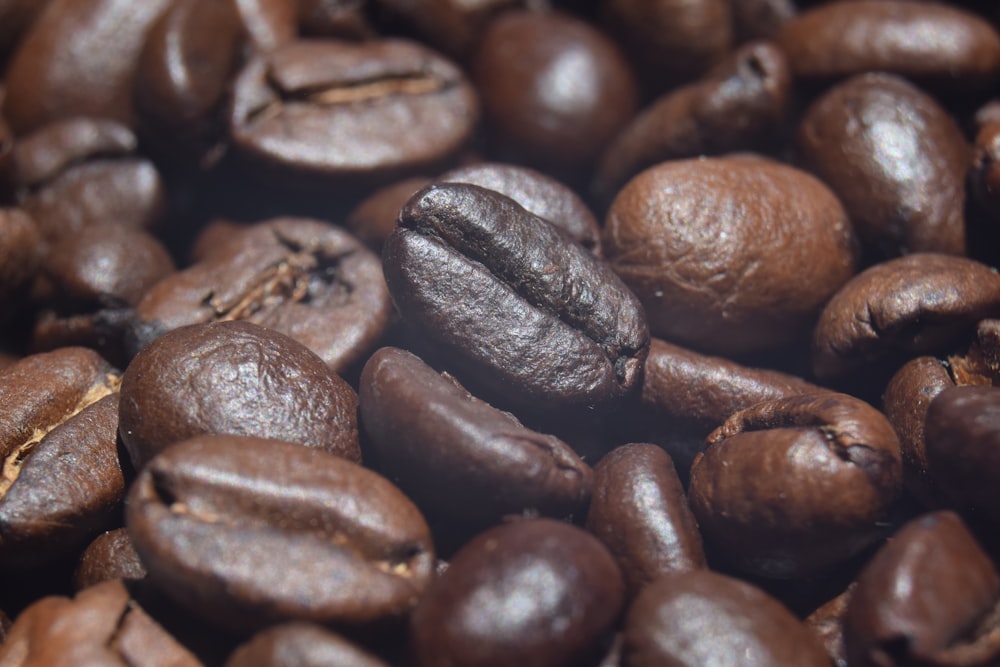 a pile of coffee beans with some coffee beans in the middle