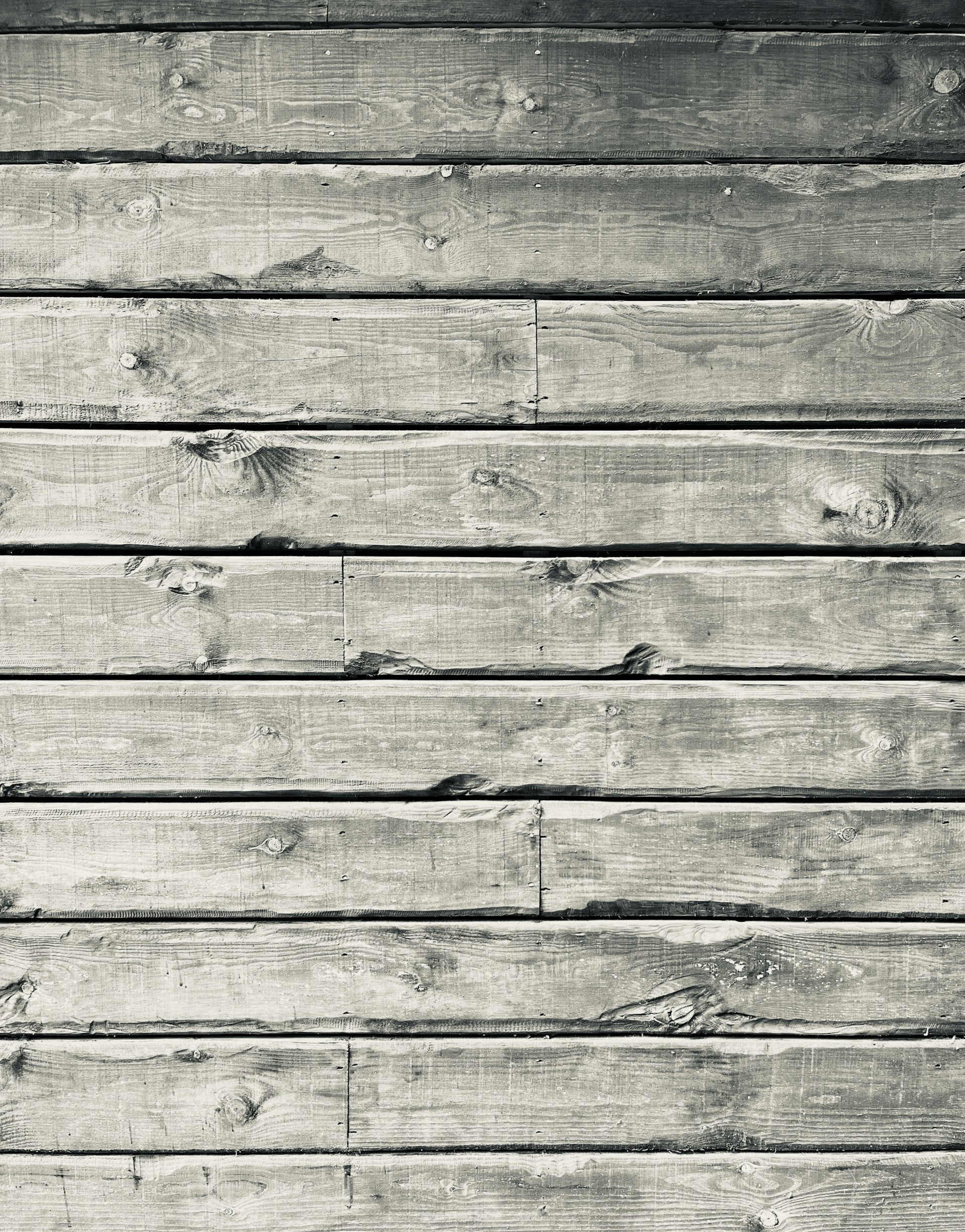 a black and white photo of a wooden wall