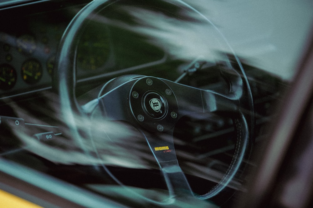 the interior of a car with a steering wheel and dashboard