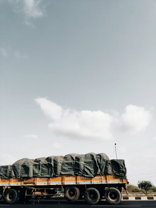A sturdy Trusthaul truck loaded with cargo, ready to hit the road on a clear day.