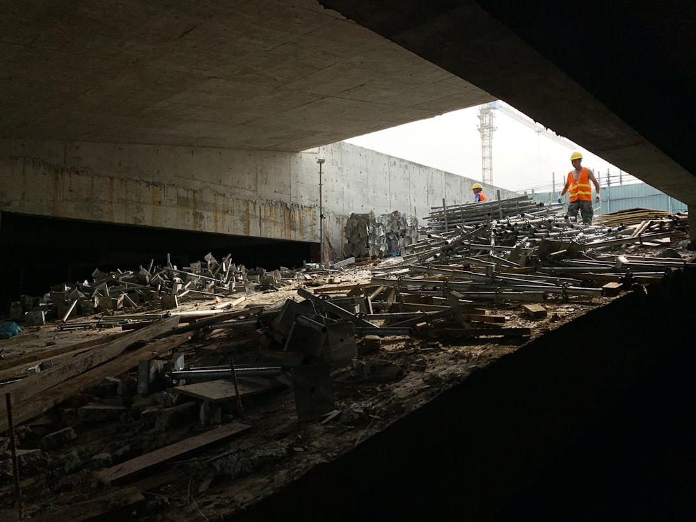 a construction worker standing in the middle of a pile of rubble