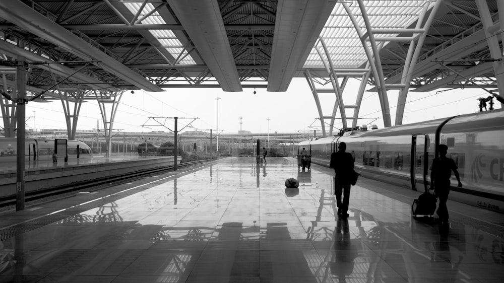 a black and white photo of a train station