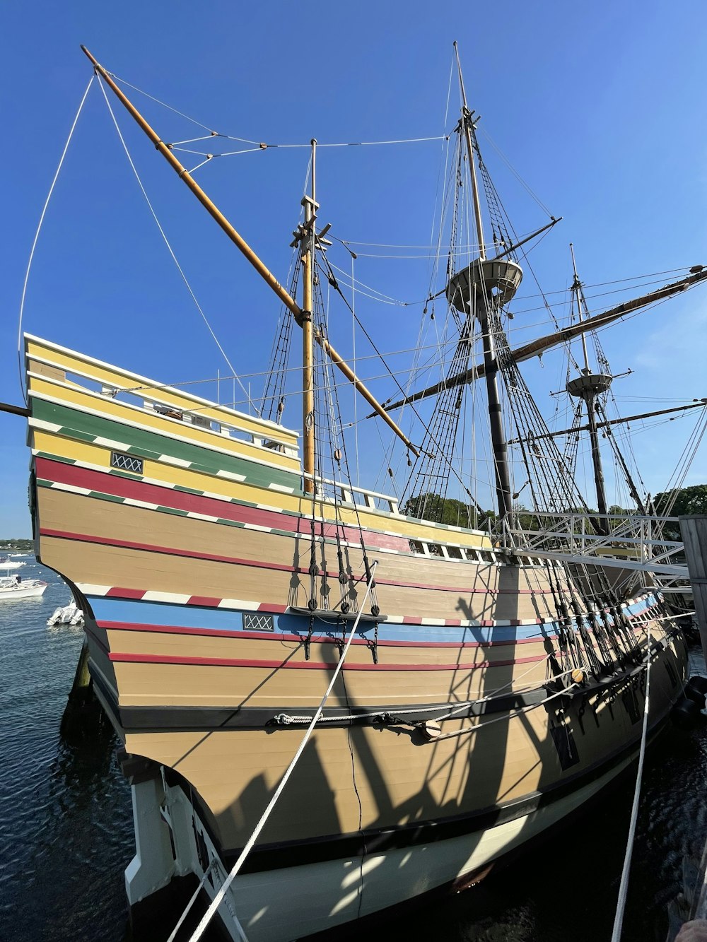 a large wooden boat docked at a pier