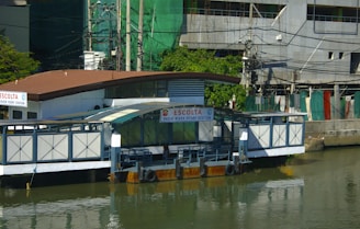 a house boat floating on top of a body of water