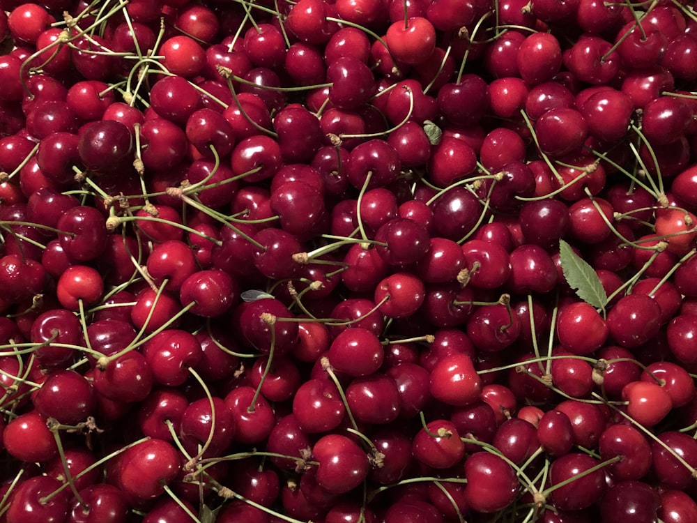 a pile of cherries sitting on top of each other