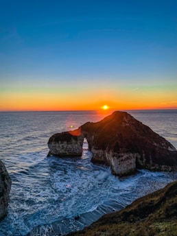 Scenic view of the rugged coastline and geological formations in Geoparque Ortegal at sunset
