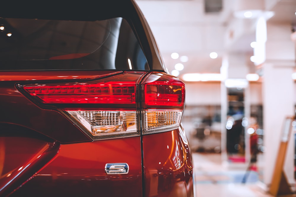 a close up of the tail lights of a red car