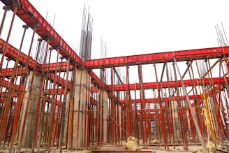 a building under construction with lots of red scaffolding