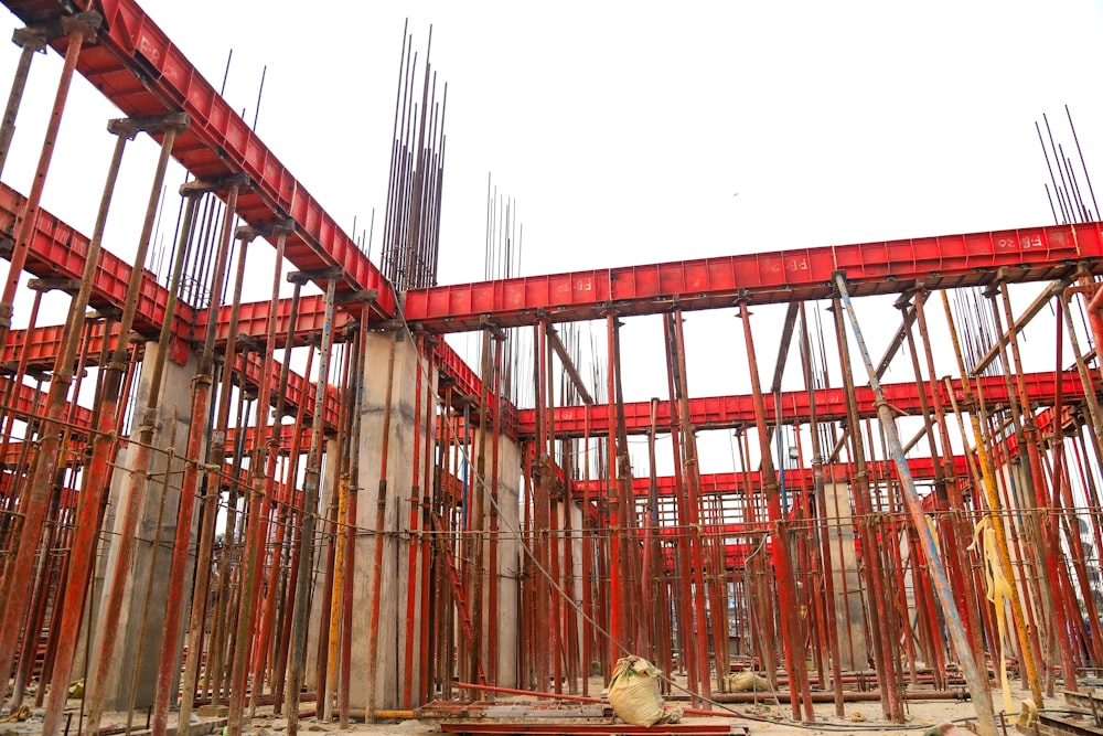 a building under construction with lots of red scaffolding