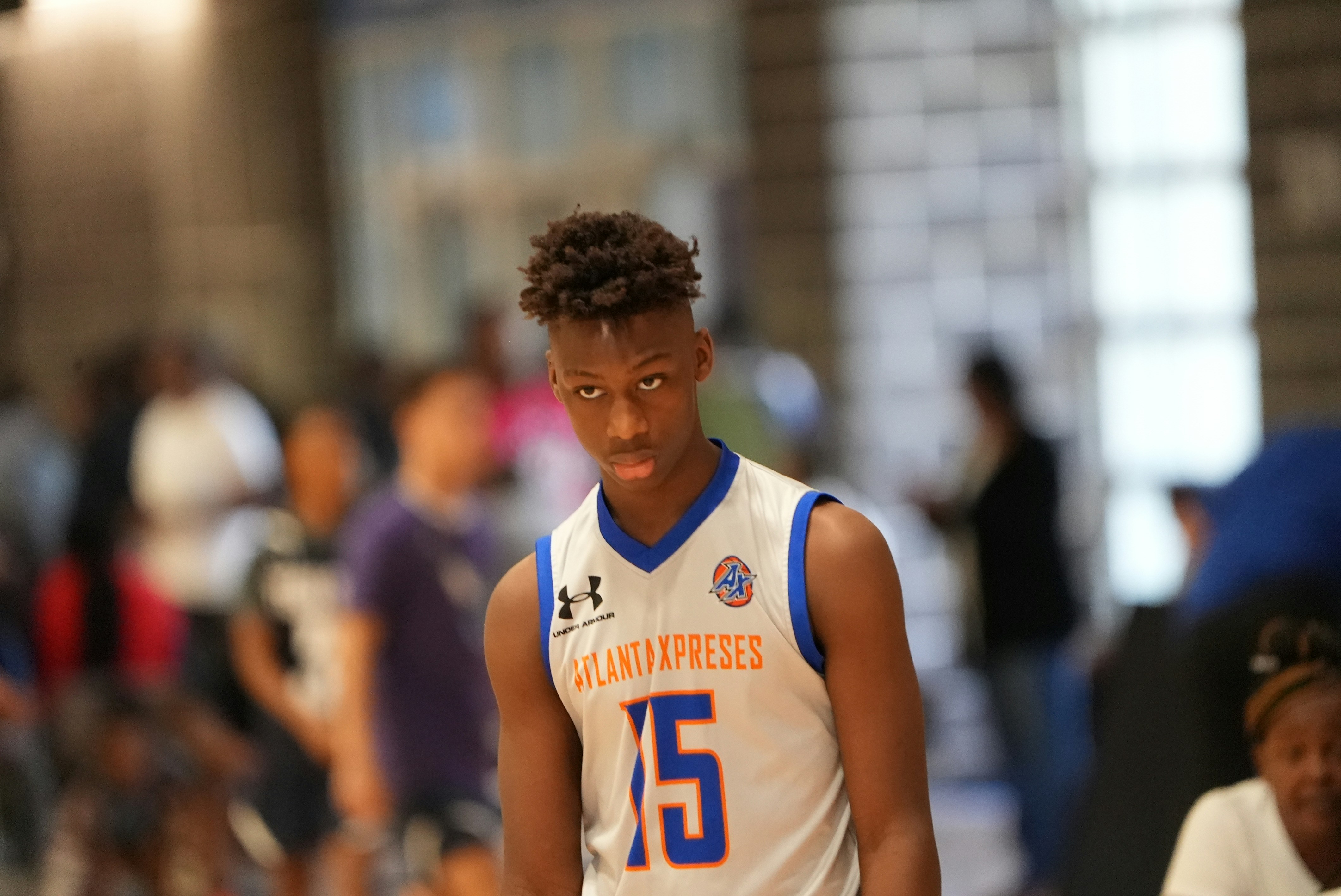 a young man in a white and blue basketball uniform