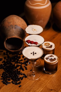 a wooden table topped with glasses filled with drinks