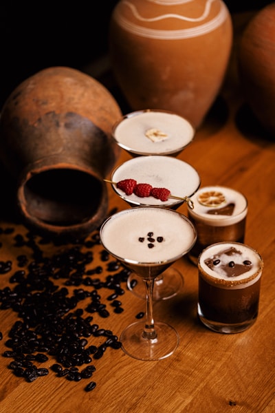 a wooden table topped with glasses filled with drinks
