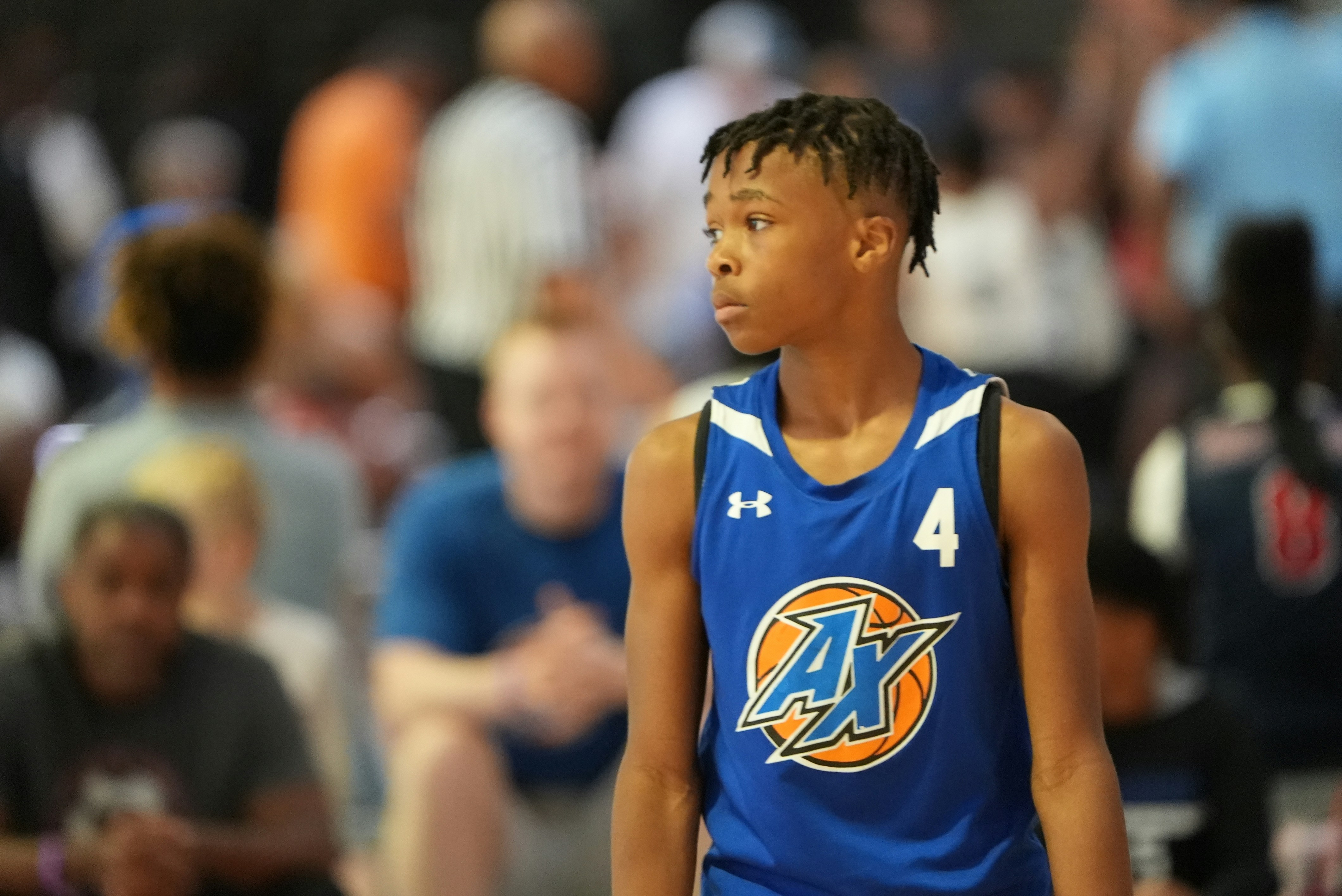 a young man standing in front of a crowd of people