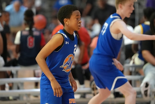 a group of young men playing a game of basketball