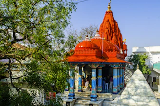 a colorfully painted temple in the middle of a park